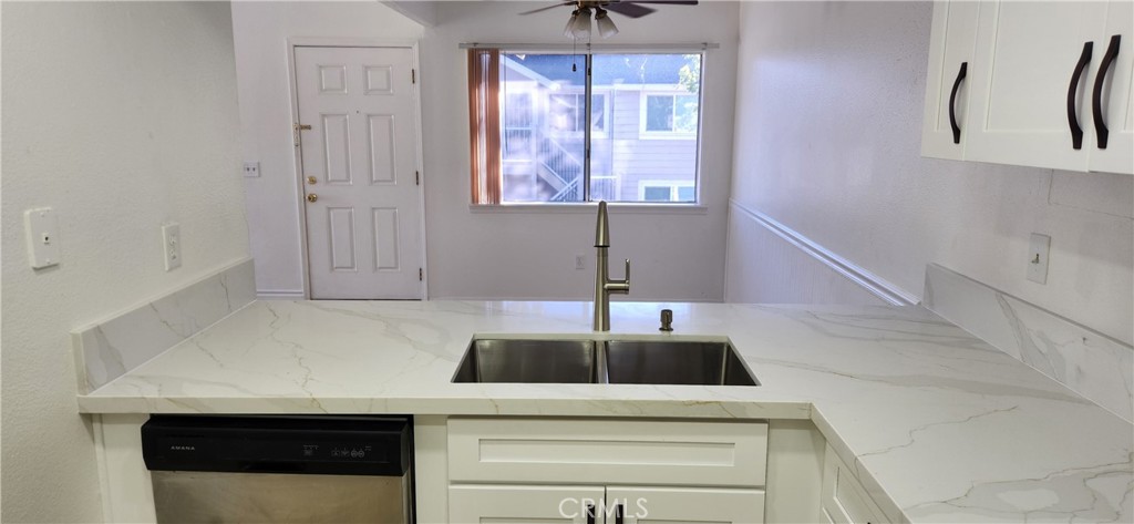 713 Walnut Drive Lake Elsinore, CA 92530 - Photo 2 of 28 a kitchen with a sink and cabinets