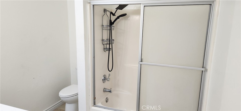 713 Walnut Drive Lake Elsinore, CA 92530 - Photo 22 of 28 a bathroom with a shower toilet and sink