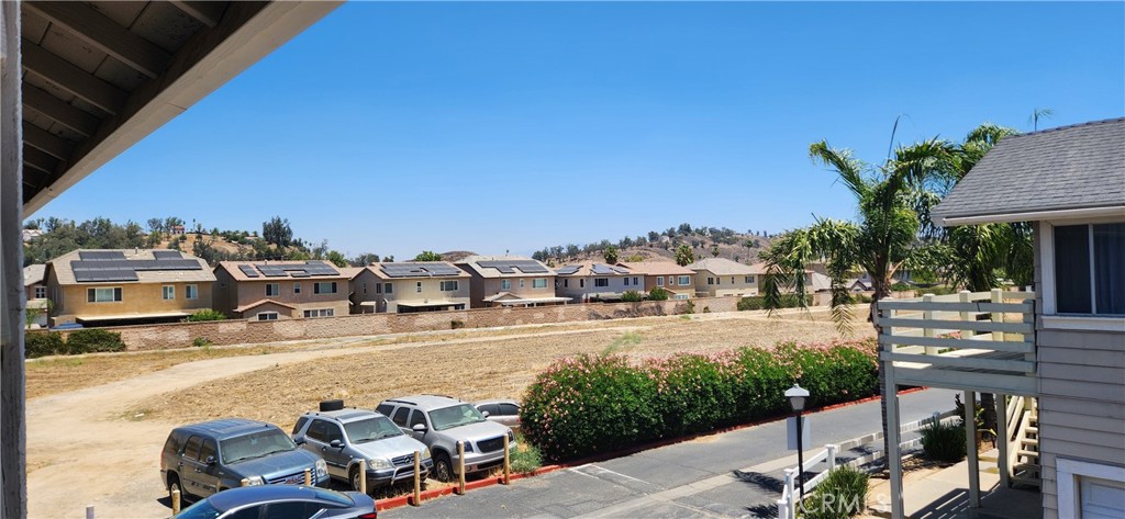 713 Walnut Drive Lake Elsinore, CA 92530 - Photo 27 of 28 a view of a patio with table and chairs potted plants with wooden floor and city view