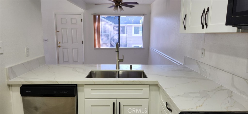 713 Walnut Drive Lake Elsinore, CA 92530 - Photo 4 of 28 a kitchen with a sink and a window