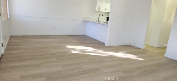a view of a room with wooden floor
