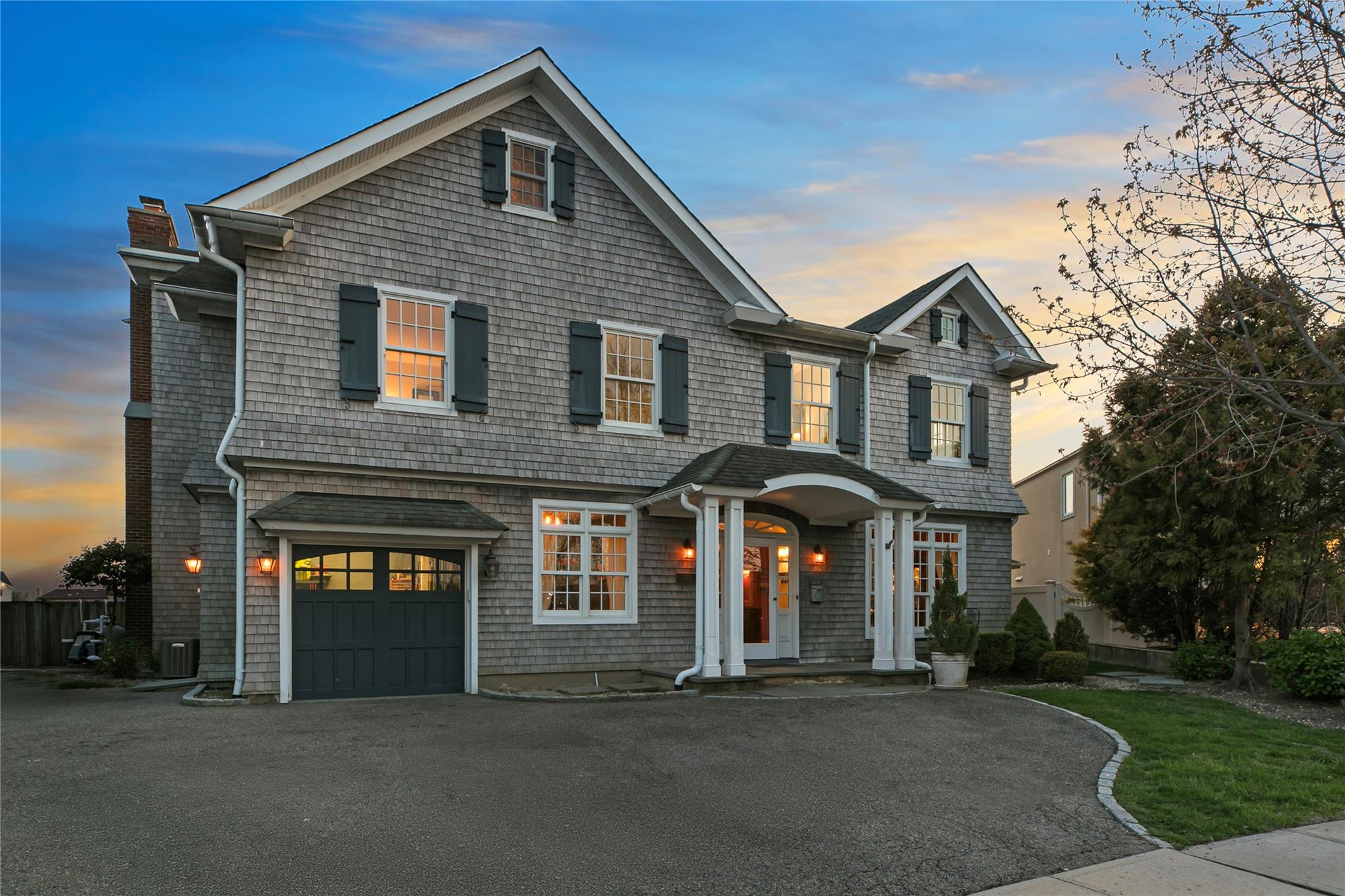 3076 Riverside Drive Wantagh, NY 11793 - Photo 1 of 1 View of front of home with driveway, a chimney, and a garage