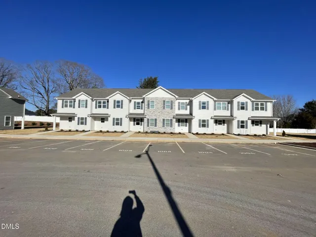 a view of multiple houses with a street
