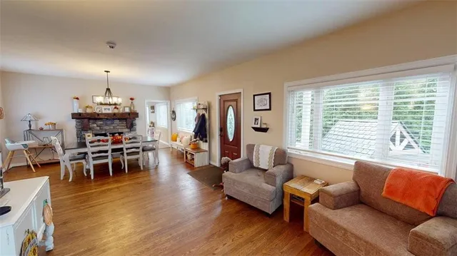 a view of a workspace with furniture and wooden floor