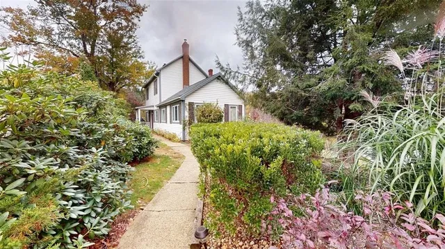 a front view of a house with a garden
