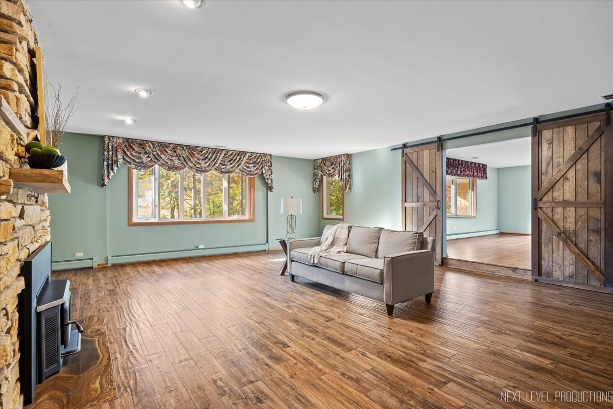 49W794 Lenschow Road Sycamore, IL 60178 - Photo 11 of 40 a living room with furniture and a wooden floor