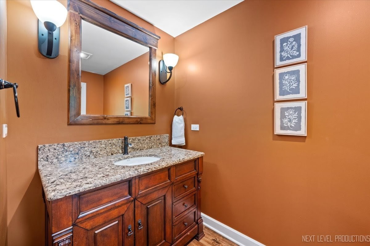 49W794 Lenschow Road Sycamore, IL 60178 - Photo 16 of 40 a bathroom with a sink and a mirror