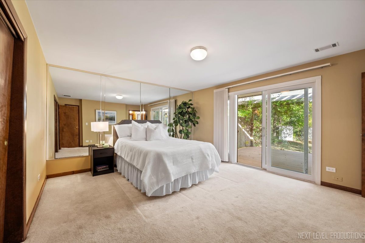 49W794 Lenschow Road Sycamore, IL 60178 - Photo 22 of 40 a bed room with a bed and a large window