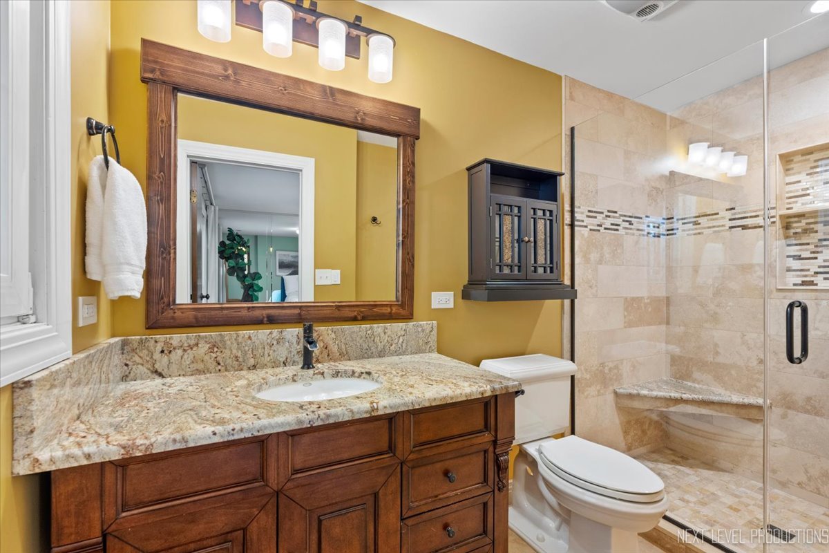 49W794 Lenschow Road Sycamore, IL 60178 - Photo 23 of 40 a bathroom with a granite countertop sink toilet and shower