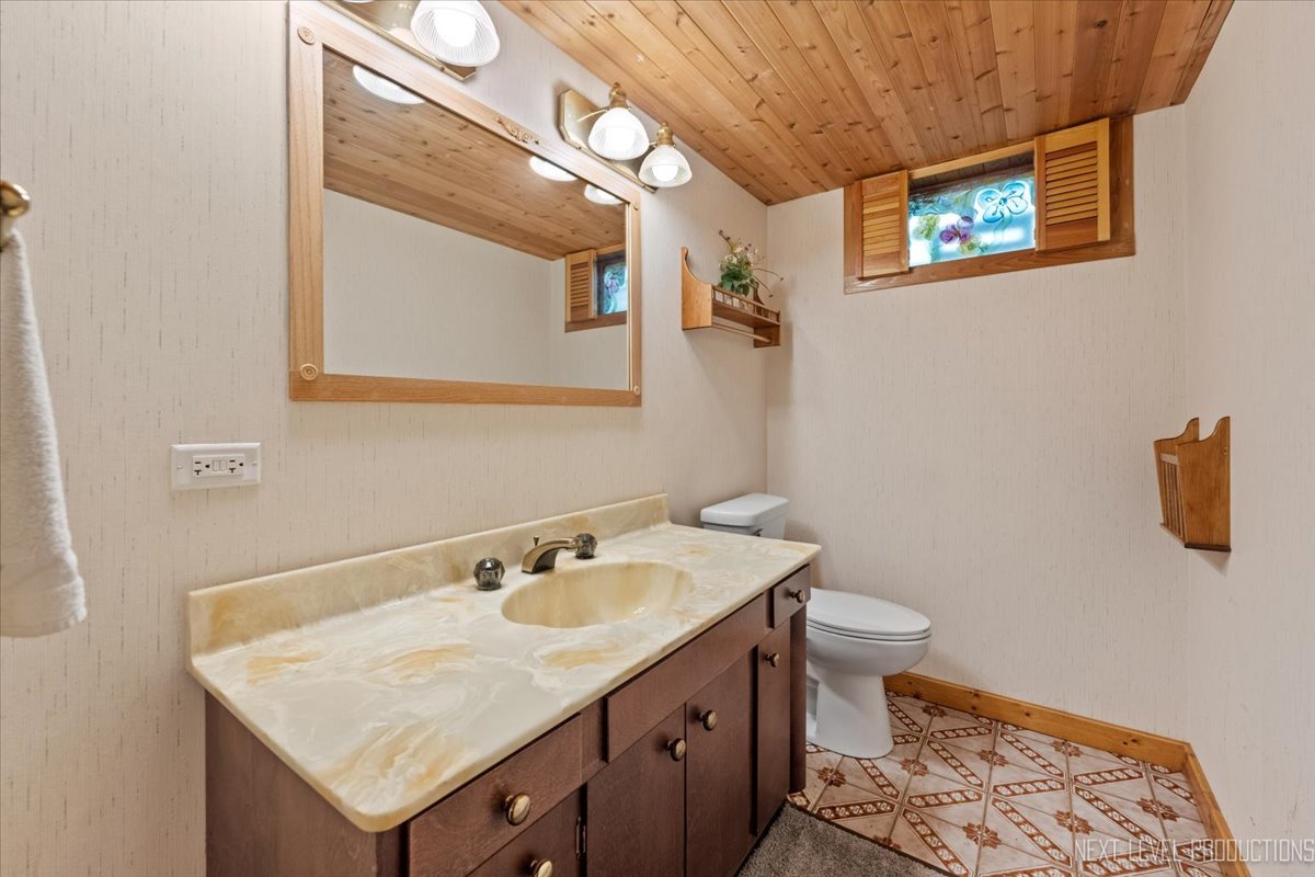 49W794 Lenschow Road Sycamore, IL 60178 - Photo 33 of 40 a bathroom with a sink a toilet and a mirror