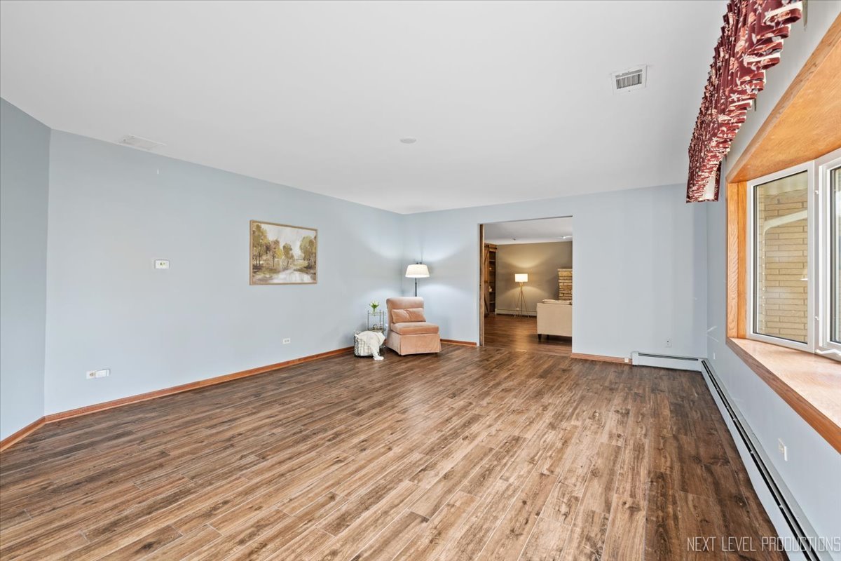 49W794 Lenschow Road Sycamore, IL 60178 - Photo 6 of 40 a view of a room with wooden floor lounge chair and windows