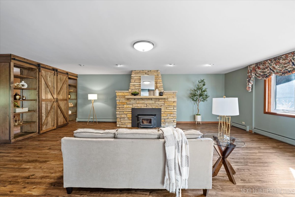 49W794 Lenschow Road Sycamore, IL 60178 - Photo 9 of 40 a living room with furniture and a fireplace