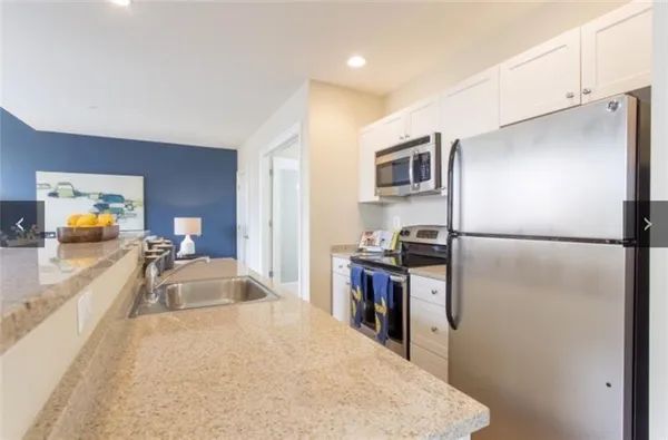 a kitchen with a refrigerator and a sink