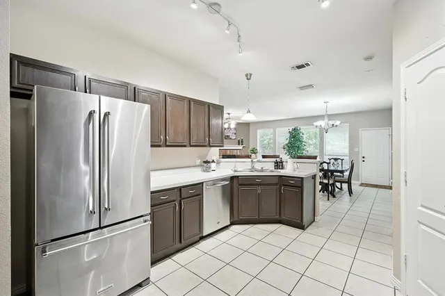 a kitchen with kitchen island granite countertop a stove cabinets and refrigerator