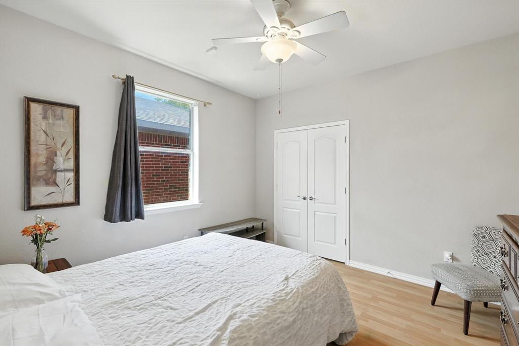 13521 Ponderosa Ranch Road Fort Worth, TX 76262 - Photo 19 of 27 a bedroom with a bed and a window