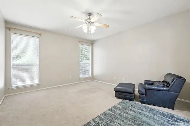 an empty room with closet and ceiling fan