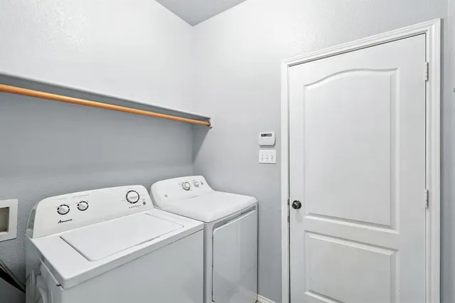 a view of backyard with wooden fence