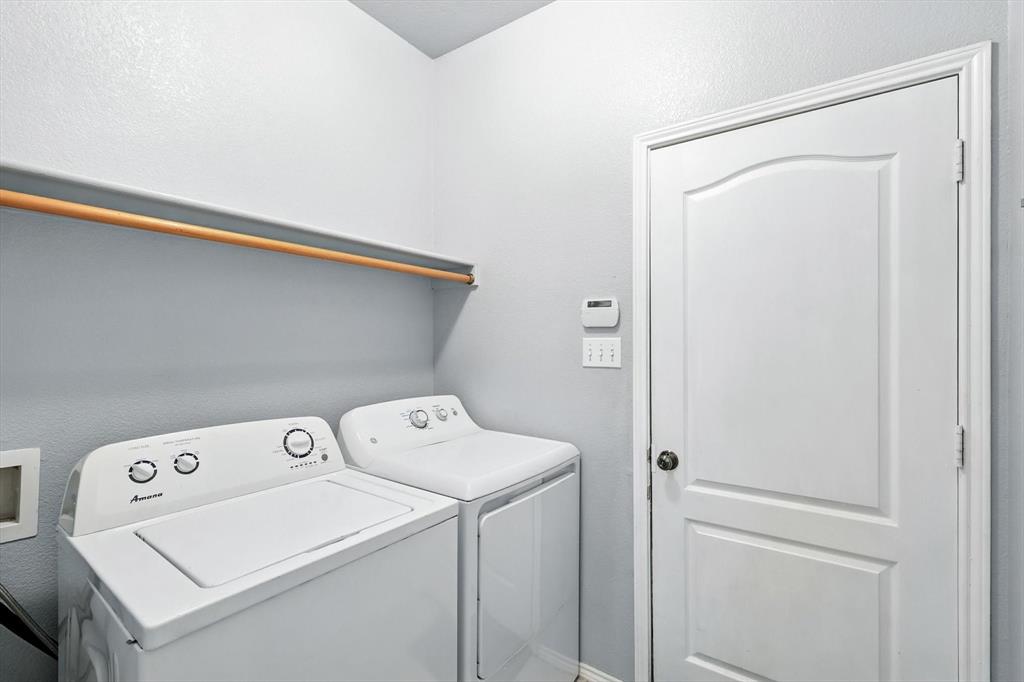 13521 Ponderosa Ranch Road Fort Worth, TX 76262 - Photo 23 of 27 a utility room with dryer and washer