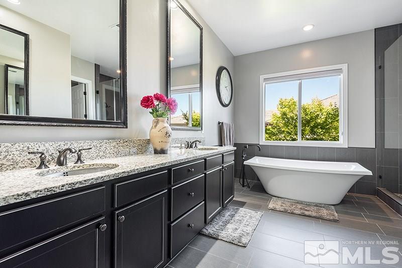 10055 Gold Cup Lane Reno, NV 89521 - Photo 14 of 25 a bathroom with a bathtub sink mirror and toilet
