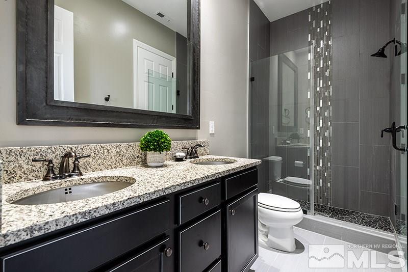 10055 Gold Cup Lane Reno, NV 89521 - Photo 18 of 25 a bathroom with a granite countertop sink mirror and toilet