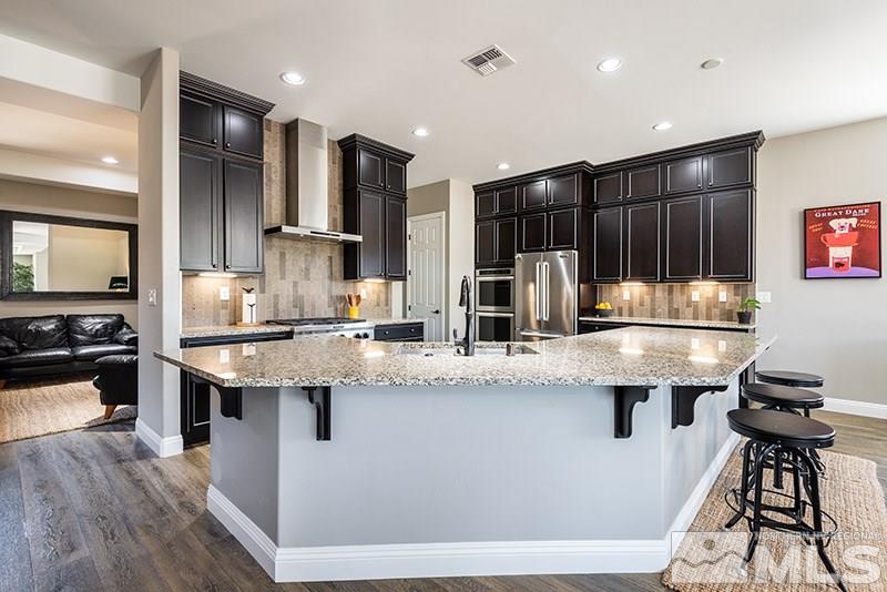 10055 Gold Cup Lane Reno, NV 89521 - Photo 6 of 25 a kitchen with counter top space cabinets and stainless steel appliances