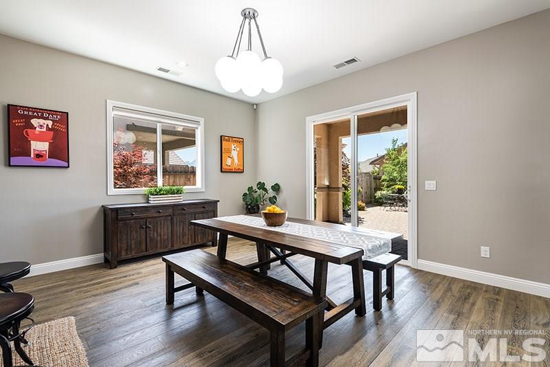 10055 Gold Cup Lane Reno, NV 89521 - Photo 10 of 25 a view of a dining room with furniture window and wooden floor