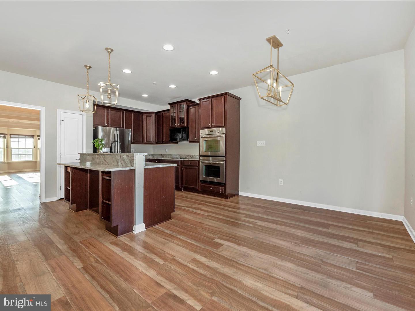 208 B Mill Pond Road Frederick, MD 21701 - Photo 10 of 45 a open kitchen with kitchen island a island wooden cabinets stainless steel appliances and a fireplace