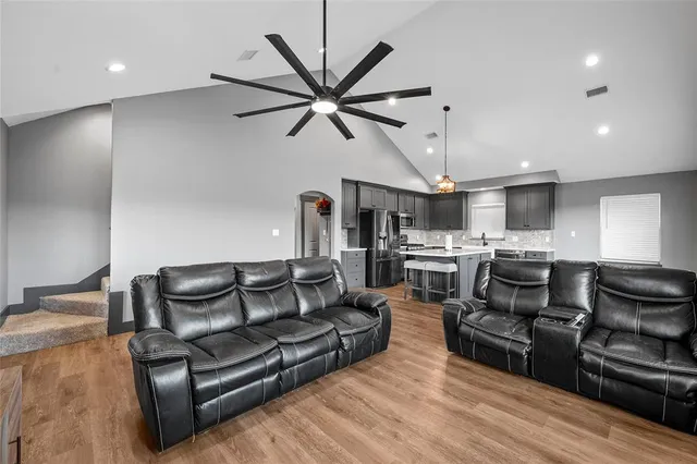 a living room with furniture and kitchen view
