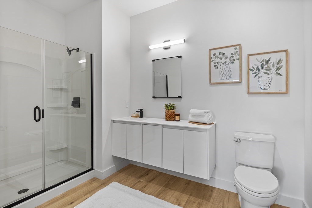 635 Main Street, Unit TH6 Wilmington, MA 01887 - Photo 11 of 29 a bathroom with a toilet a sink a shower and mirror
