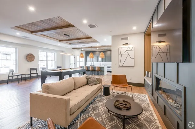 a living room with furniture a rug and a large window