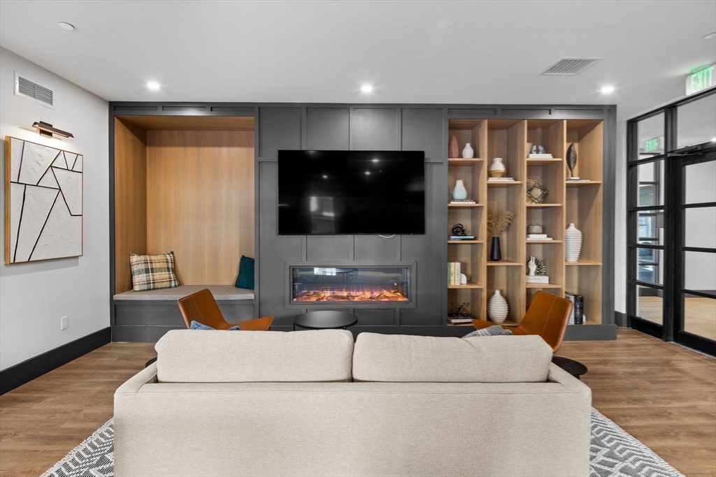 635 Main Street, Unit TH6 Wilmington, MA 01887 - Photo 22 of 29 a living room with furniture and a flat screen tv