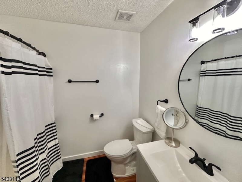 211 Sunshine Court Sayreville, NJ 08859 - Photo 12 of 15 a bathroom with a sink toilet and shower