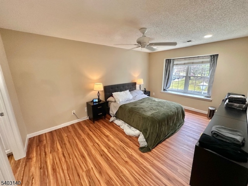 211 Sunshine Court Sayreville, NJ 08859 - Photo 9 of 15 a bedroom with a bed and wooden floor