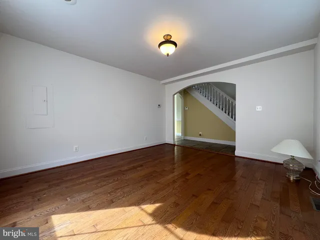 a view of room with wooden floor and fan