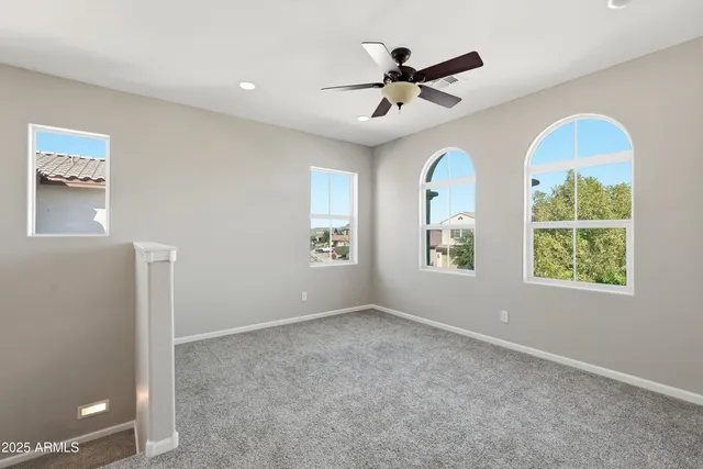 a view of a livingroom with a ceiling fan and window