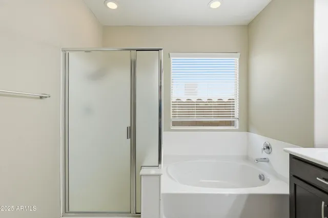 a bathroom with a bathtub and a shower
