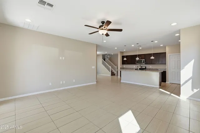 a view of a kitchen with furniture and a ceiling fan