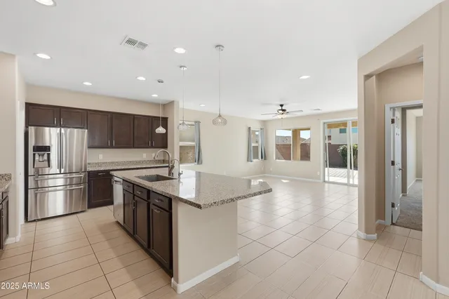 a kitchen with stainless steel appliances granite countertop a refrigerator and a sink