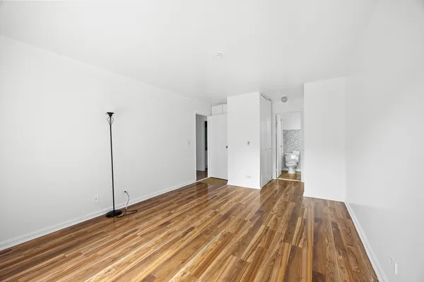 a view of a room with wooden floor