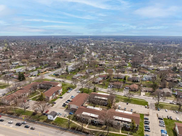 an aerial view of residential building with green space