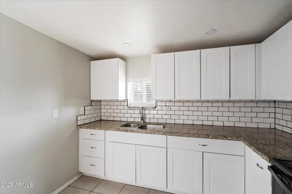 a kitchen with a refrigerator and a stove top oven