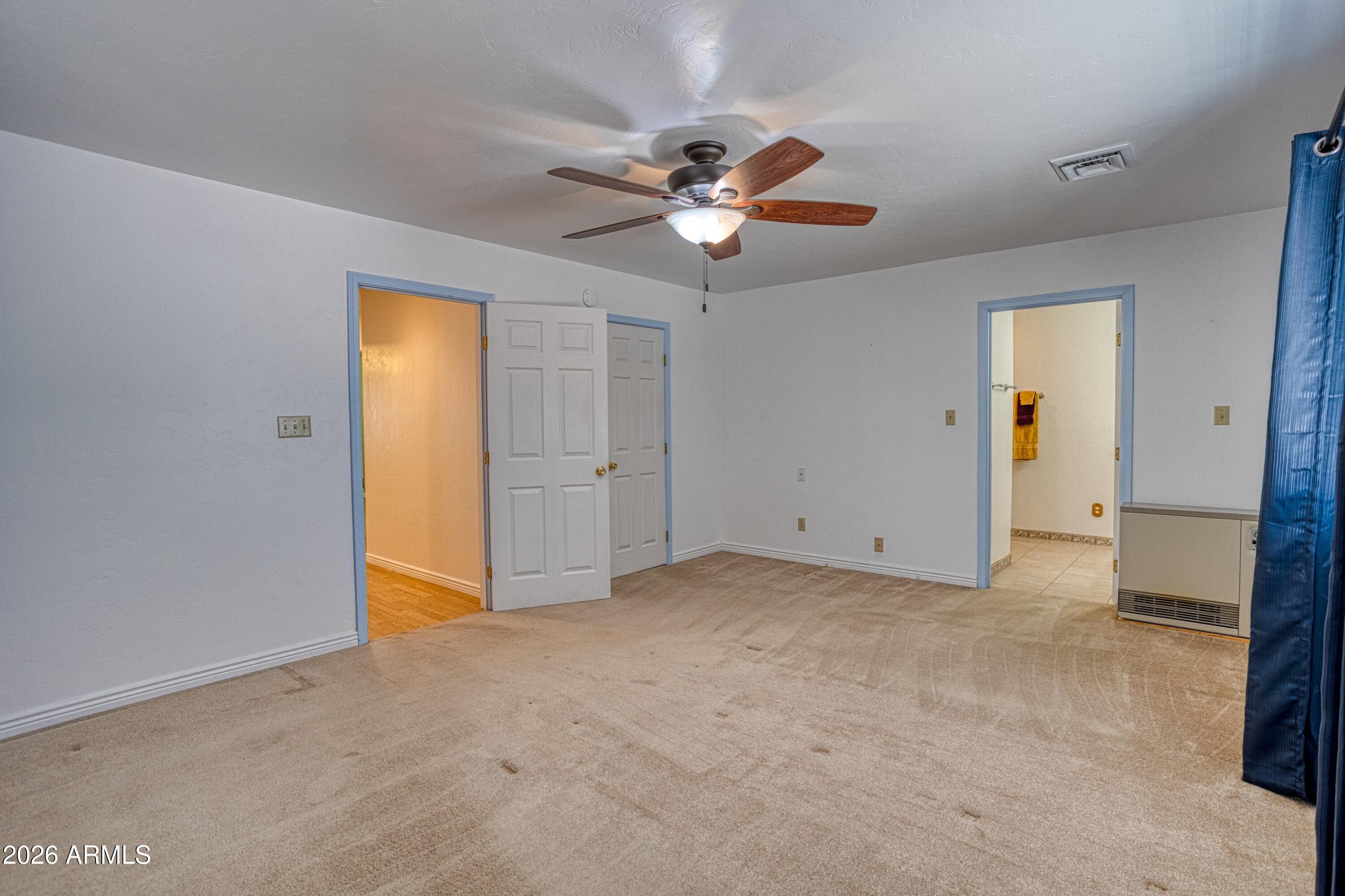 949 Geronimo Lane Show Low, AZ 85901 - Photo 17 of 43 a view of a livingroom with a chandelier fan and a ceiling fan
