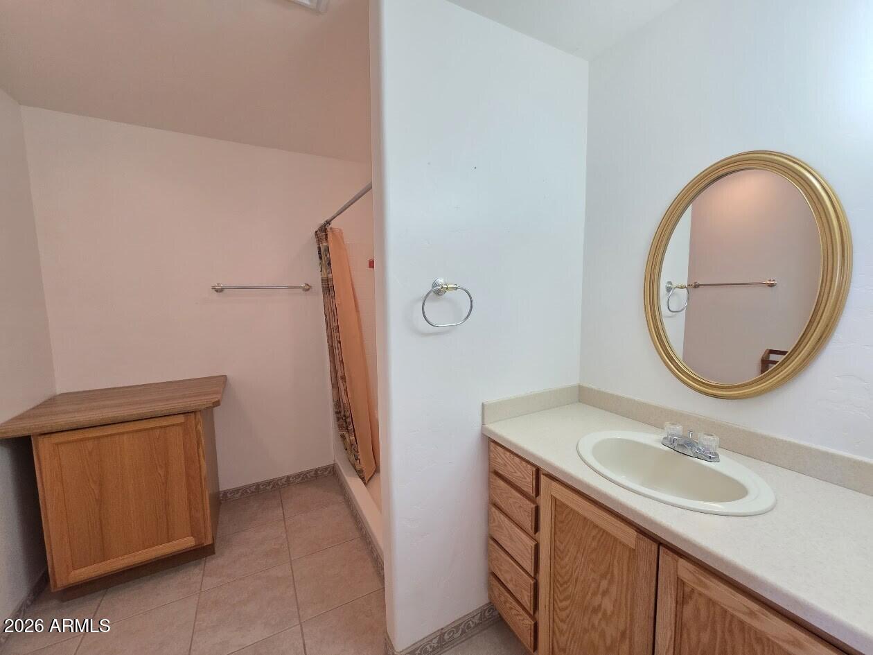 949 Geronimo Lane Show Low, AZ 85901 - Photo 23 of 43 a bathroom with a sink a vanity and a mirror
