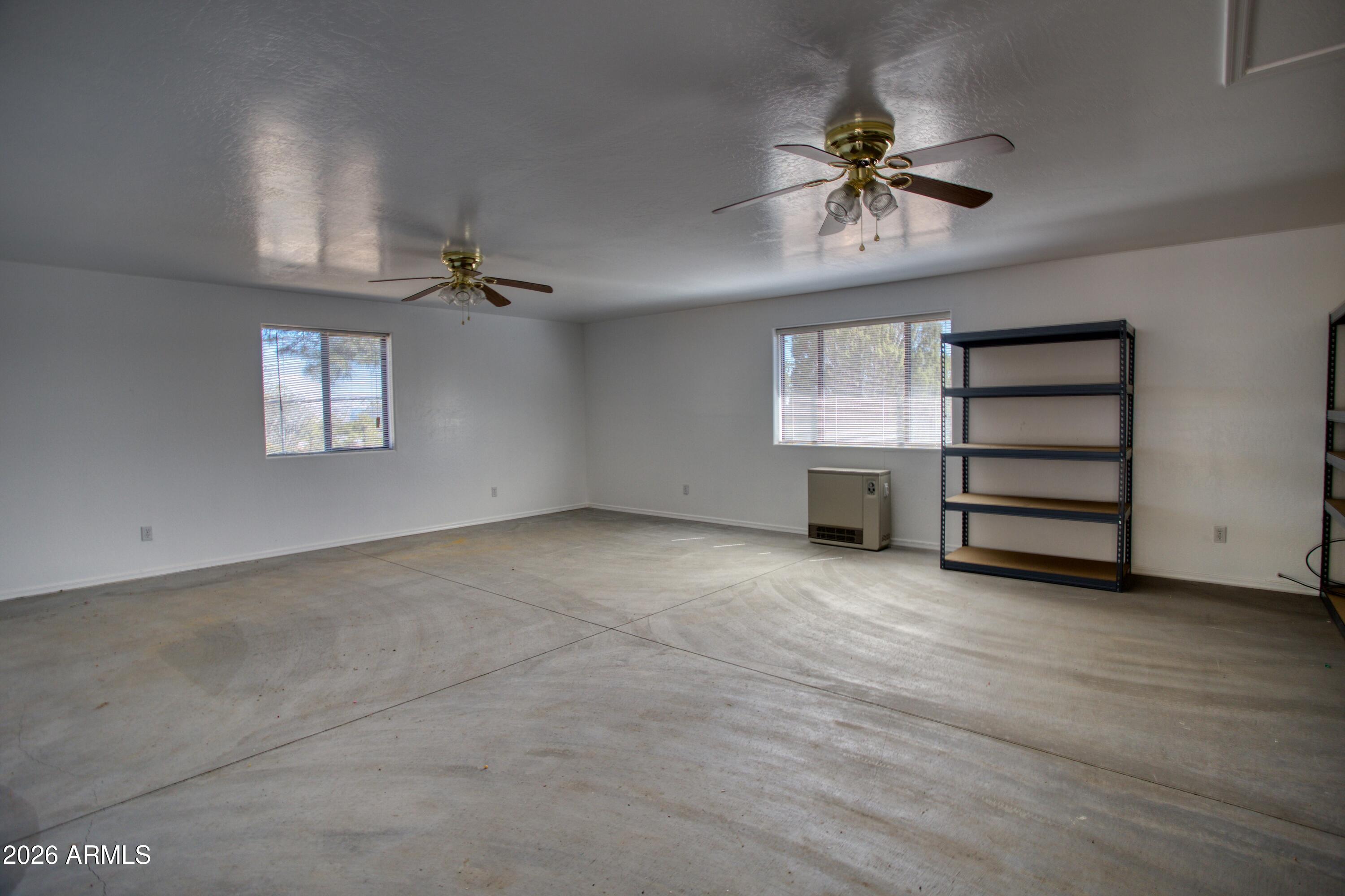 949 Geronimo Lane Show Low, AZ 85901 - Photo 31 of 43 a view of a livingroom with a ceiling fan and window