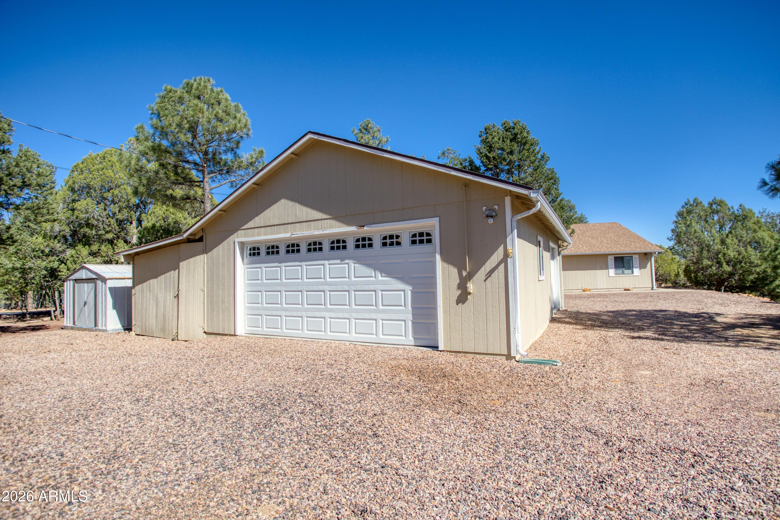 949 Geronimo Lane Show Low, AZ 85901 - Photo 36 of 43 a front view of a house with a yard and garage