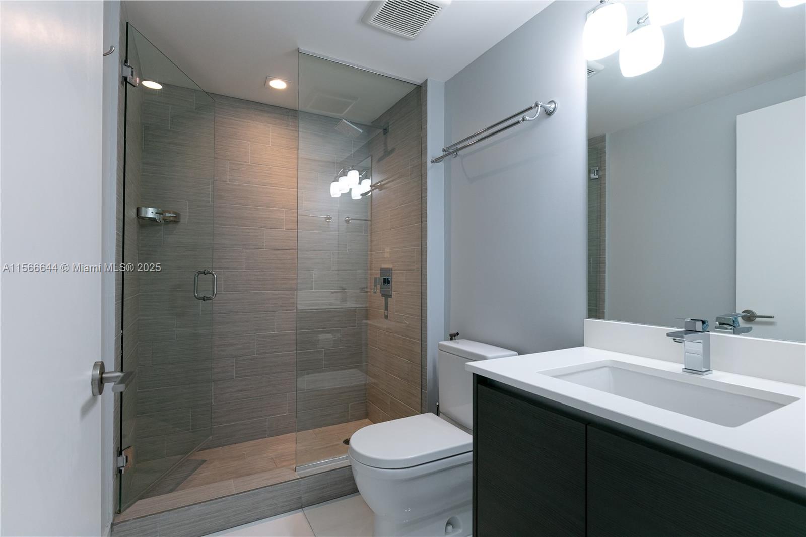 330 Sunny Isles Boulevard, Unit 51103 Sunny Isles Beach, FL 33160 - Photo 11 of 34 a bathroom with a sink toilet and shower