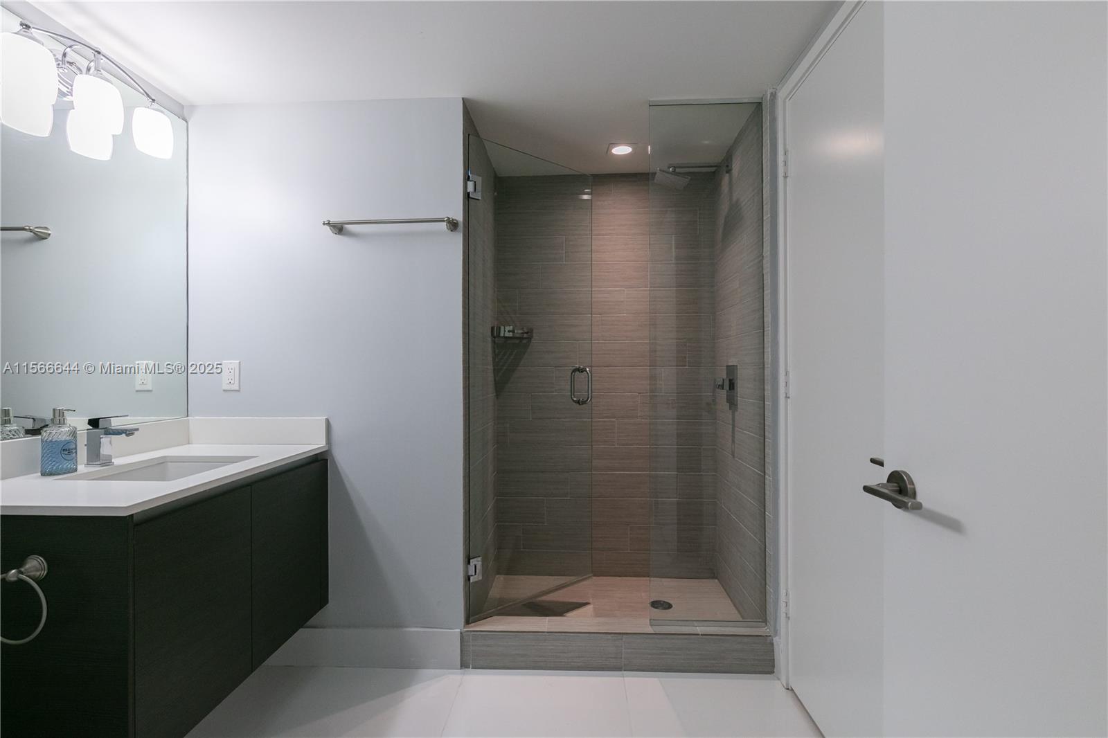 330 Sunny Isles Boulevard, Unit 51103 Sunny Isles Beach, FL 33160 - Photo 12 of 34 a bathroom with a sink and mirror