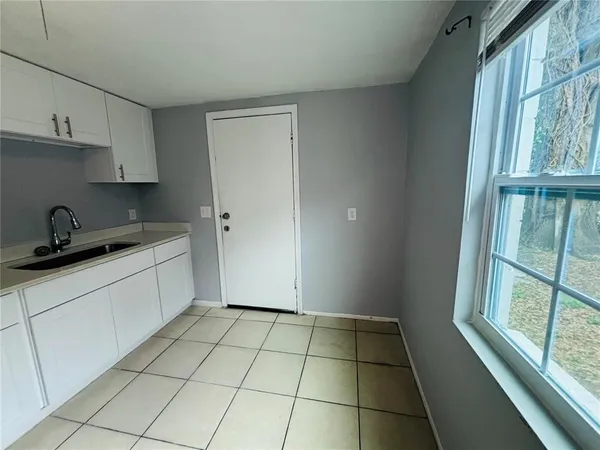 a kitchen with a sink a stove and cabinets