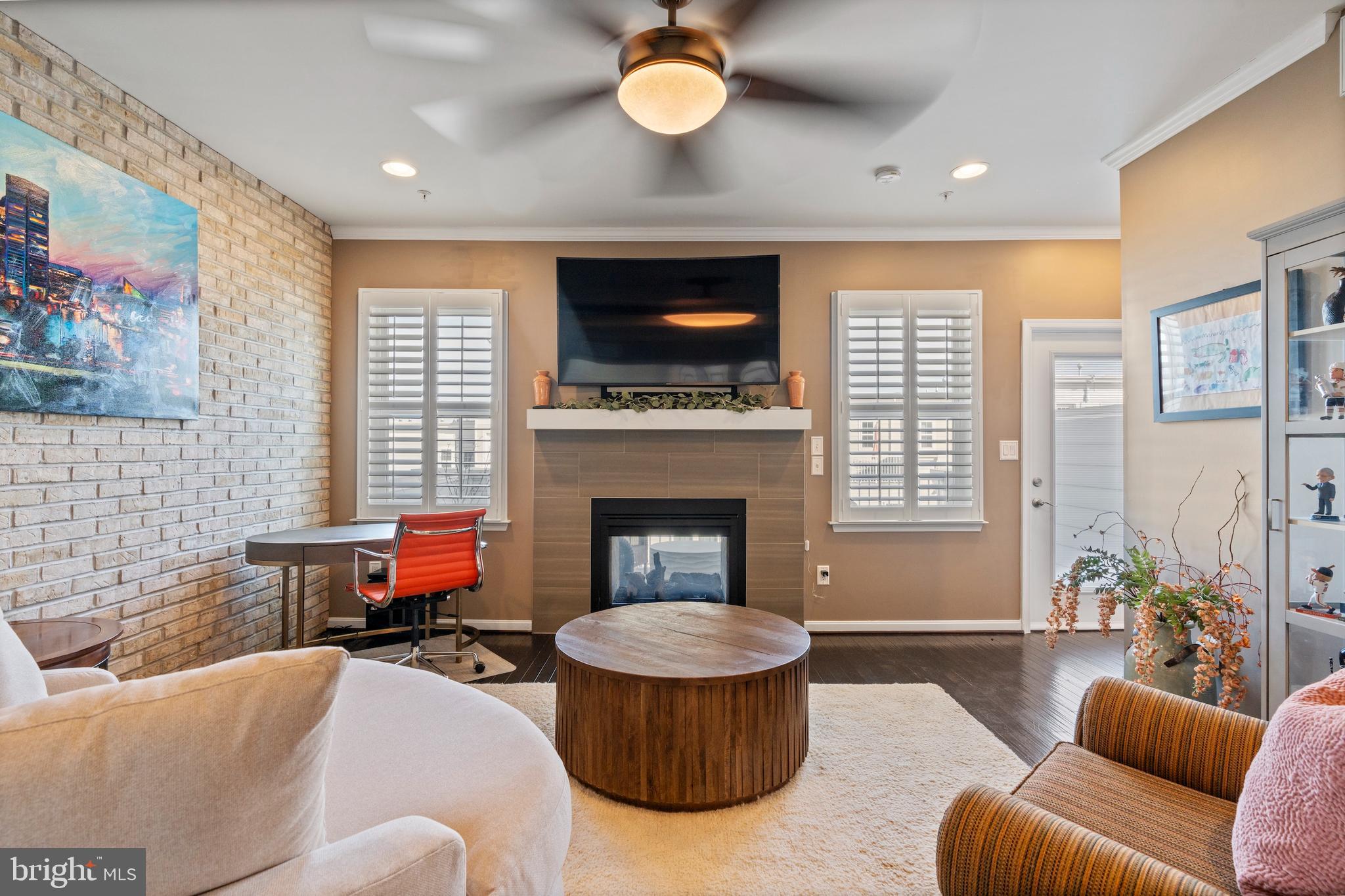 1311 Belt Street Baltimore, MD 21230 - Photo 22 of 65 a living room with furniture a flat screen tv and a fireplace