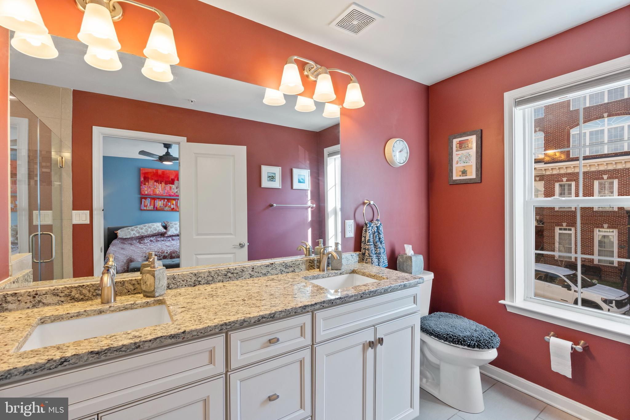 1311 Belt Street Baltimore, MD 21230 - Photo 24 of 65 a bathroom with a granite countertop toilet sink and mirror
